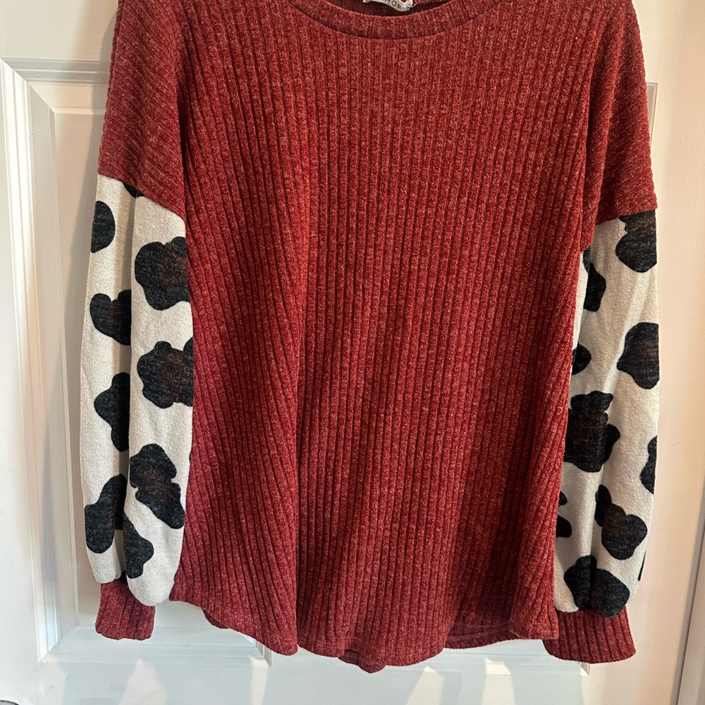 Burnt Orange Ribbed Sweater with Black and White Cow Print Sleeves